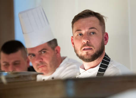 Two chefs looking towards the camera.