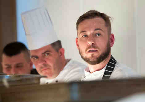 Two chefs looking towards the camera.