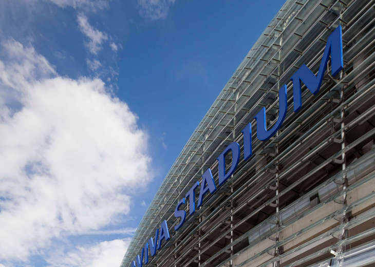 An outside view of the side of the Aviva Stadium showing the 'Aviva Stadium' sign.