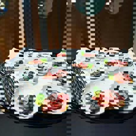 Plates of food and cutlery on a tray ready to be served.