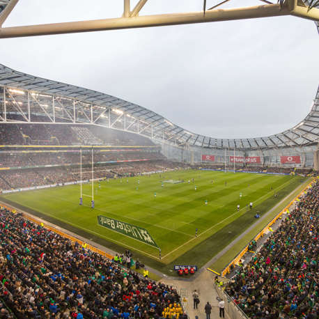 A view of the pitch at the Aviva Stadium with a rugby match taking place with a full crowd.