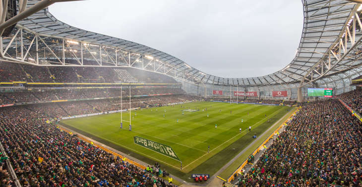 A view of the pitch at the Aviva Stadium with a rugby match taking place with a full crowd.