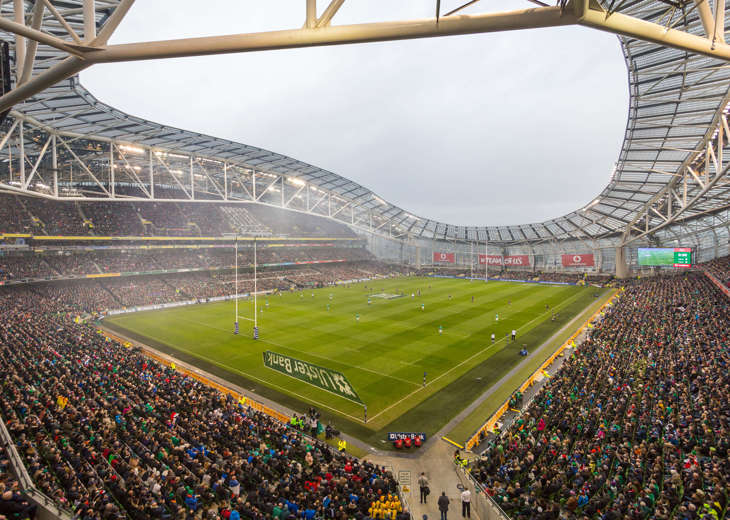 A view of the pitch at the Aviva Stadium with a rugby match taking place with a full crowd.